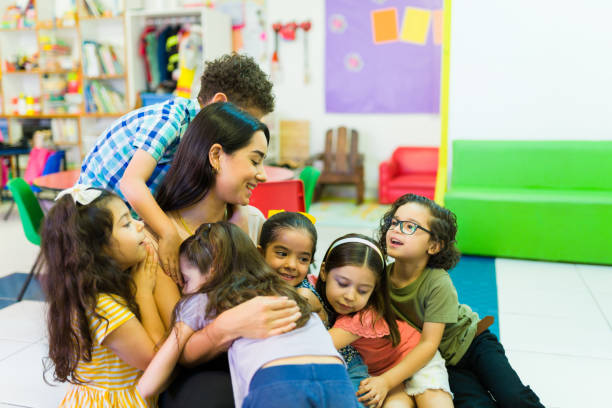 excited little kids feeling happy to see their teacher at school - little boys preschooler back to school backpack imagens e fotografias de stock