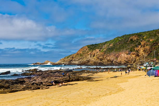 istock Rock pool and swimmers at Herolds Bay 1409983605
