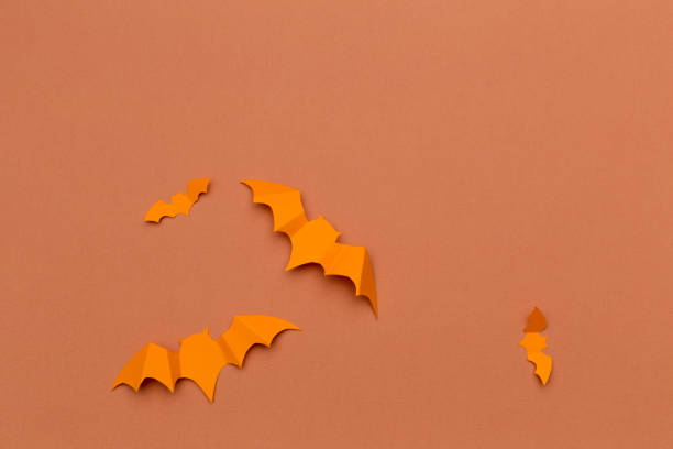 istock halloween and decoration concept - paper bats flying 1409985204