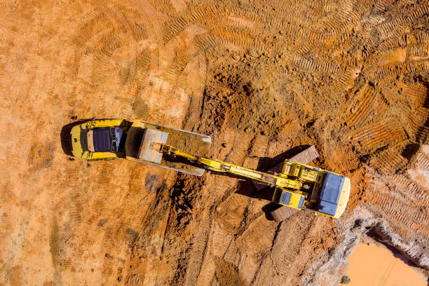 istock Excavators are used to prepare ground for loading into dump trucks on construction sites by dumping earth with excavators 1409986450