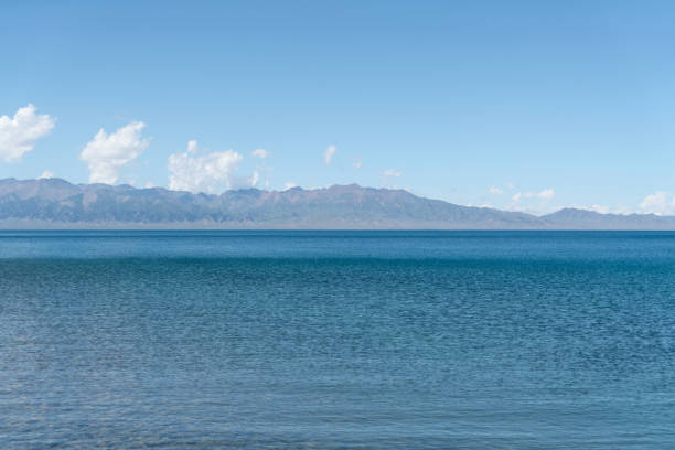 calm surface of the lake with a sunny day. shot in sayram lake in xinjiang, china. - 塞里木湖 個照片及圖片檔