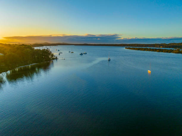 istock Sunrise over the river with boats 1409988137