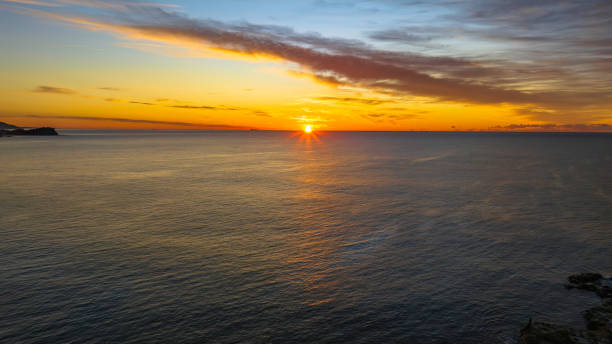 istock Sunrise over the sea with high cloud 1409988368