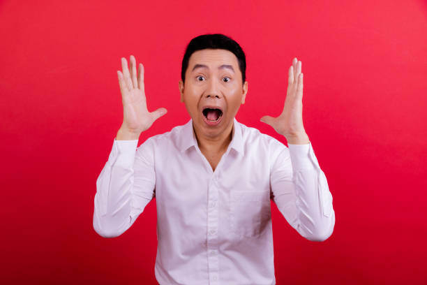 istock Young white collar worker portrait in red background. 1409993271