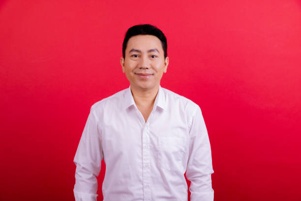 istock Young white collar worker portrait in red background. 1409993299