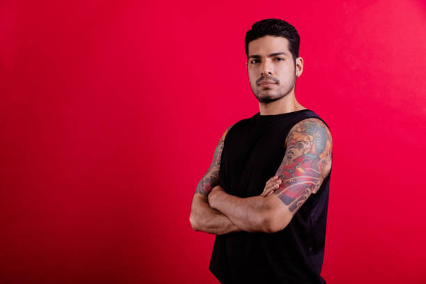 istock Young tattoo hipster portrait in red background. 1409993329