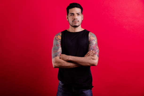 istock Young tattoo hipster portrait in red background. 1409993331