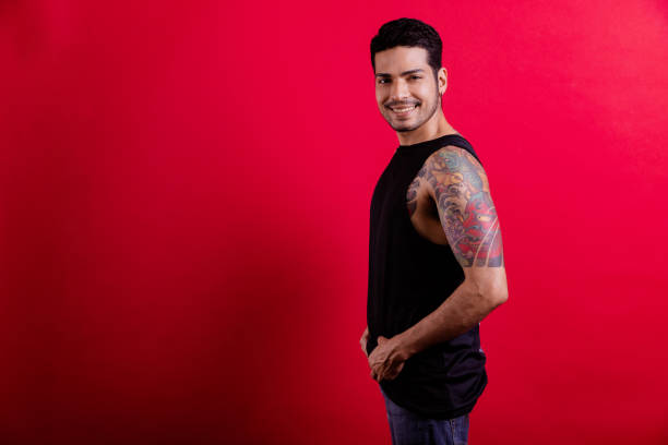 istock Young tattoo hipster portrait in red background. 1409993352