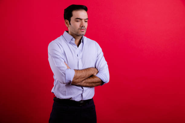 istock Young middle east white collar worker portrait in red background. 1409993418