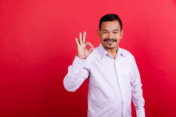 istock Bearded mature man portrait in red background. 1409993759