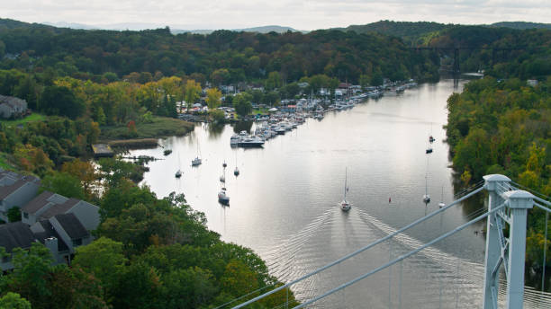 Aerial Shot of Boats Sailing on Rondout Creek in Kingston, New York Aerial shot of Kingston, New York on a partly cloudy day in autumn. kingston harbour stock pictures, royalty-free photos & images