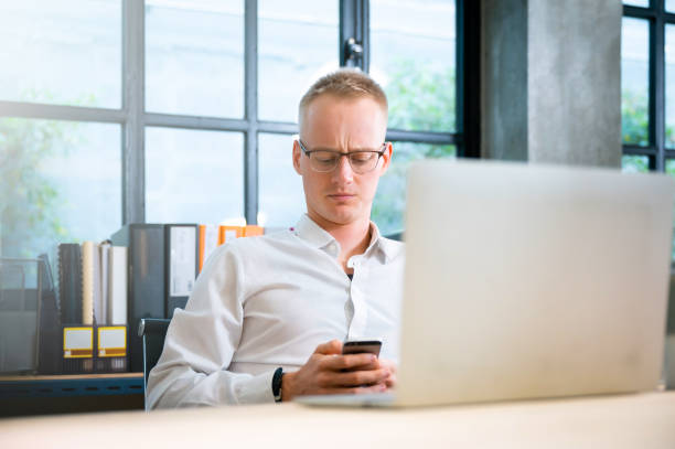 istock Businessman working in office. Young handsome man working on computer laptop at workplace 1409997229