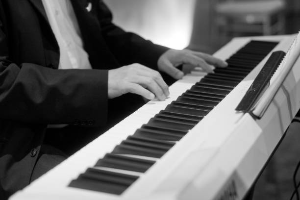 istock Hand playing electric organ on stage 1410001827