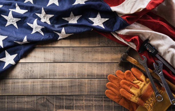 istock Happy Labor day concept. American flag with different construction tools on dark wooden background. 1410002858