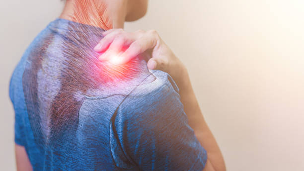 man suffering from trapezius and shoulder pain standing on white background - inflammation back physical therapy isolated on white imagens e fotografias de stock