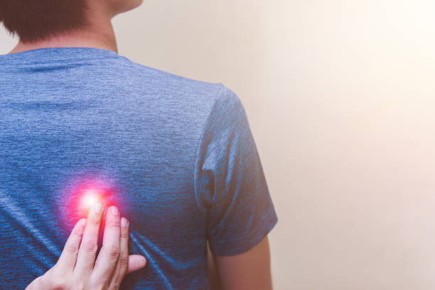 istock Man suffering from scapula pain standing on white background 1410004707