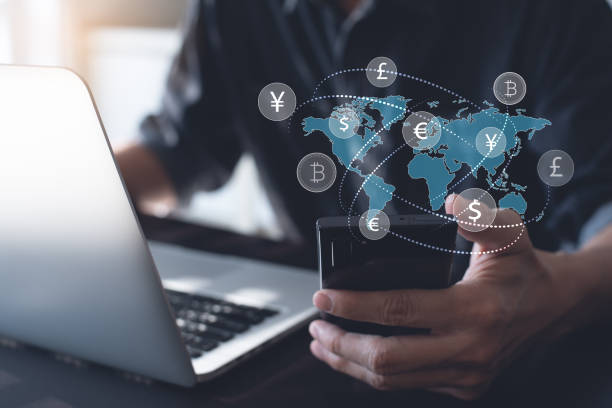 Currency exchange, money transfer, Global Business, FinTech financial technology, online banking, interbank payment concept. Currency exchange, money transfer, FinTech financial technology, Global business, online banking, interbank payment concept. Man using mobile phone and laptop computer with international currencies and world map on virtual screen exchanging stock pictures, royalty-free photos & images