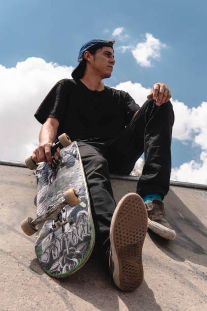 istock Young man posing on a park ramp with his skateboard 1410008256