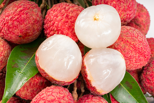 Fresh Lychee with leaves white background, Sweet lychees fruits with leaves on White