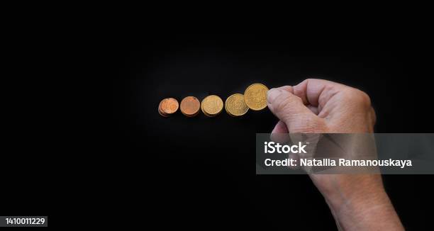 Closeup The Hand Of An Elderly Woman Lays Out Coins On A Black Background Stock Photo - Download Image Now