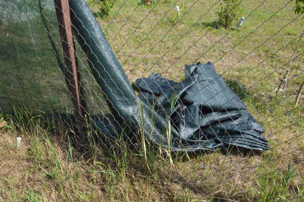 istock Installation of a shading net on a chain-link fence 1410012204