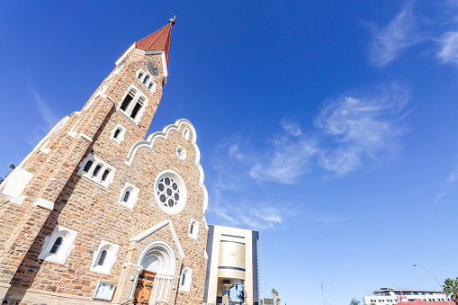 Christ Church (Christuskirche) on Robert Mugabe Avenue in Windhoek at Khomas Region, Namibia, with a commercial sign visible.