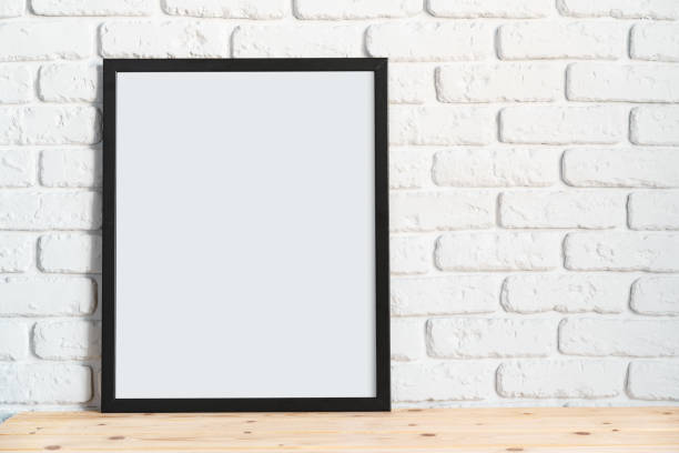 istock Photo frames on floor over white brick wall 1410015154