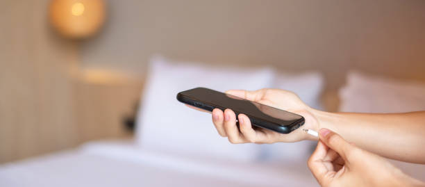 istock Hand Charging battery on mobile smartphone. Technology, multiple sharing and recharge concepts 1410015207