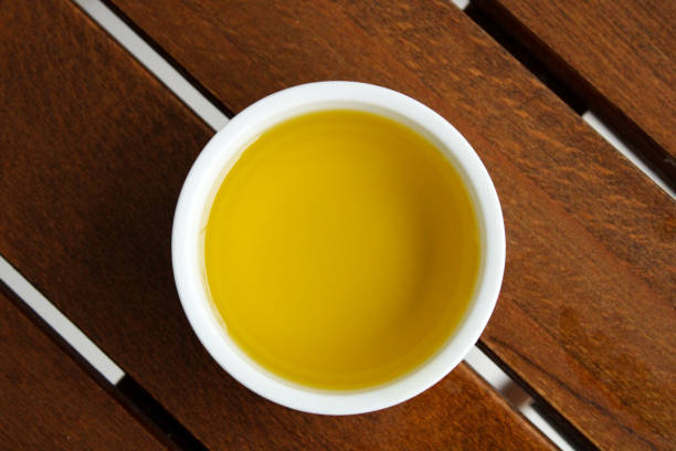 istock Olive oil in the bowl, top view 1410015524