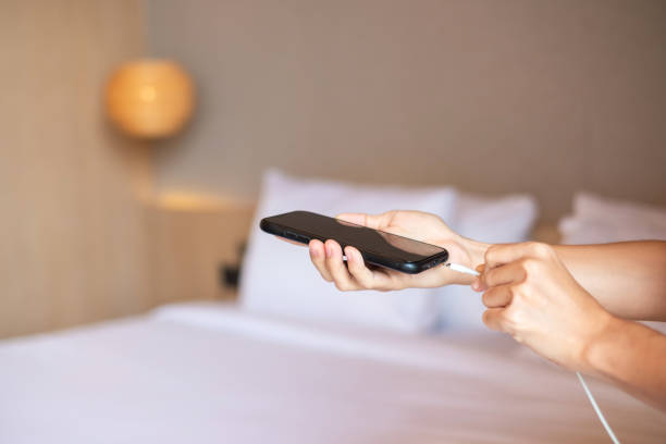 istock Hand Charging battery on mobile smartphone. Technology, multiple sharing and recharge concepts 1410015546
