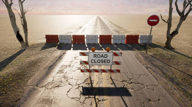 Road closed sign in a desert road, 3D illustration. stock photo