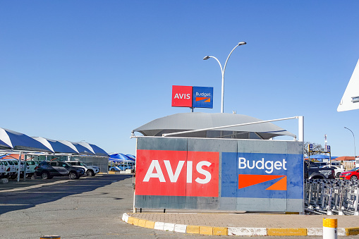 Avis Car Rental at Hosea Kutako Airport in Windhoek at Khomas Region, Namibia, with commercial signs visible.