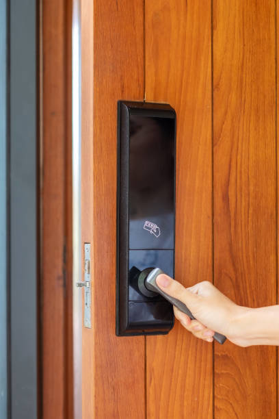 istock man holding handle of smart digital door lock while open or close the door. Technology, electrical and lifestyle concepts 1410016084