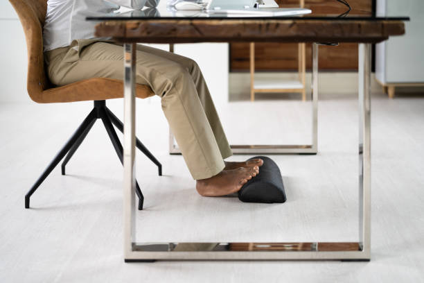 istock Footrest Against Pain In Office. Shifting Posture 1410016231