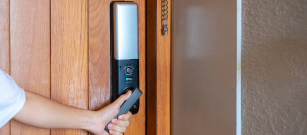 istock man holding handle of smart digital door lock while open or close the door. Technology, electrical and lifestyle concepts 1410016246
