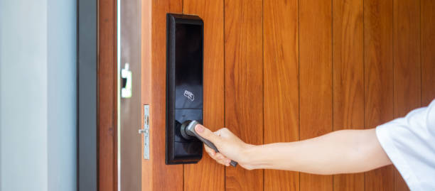 istock man holding handle of smart digital door lock while open or close the door. Technology, electrical and lifestyle concepts 1410016248
