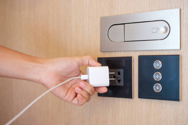 istock Closeup finger unplugging or plugging of electricity device at home. Energy Saving, power, electrical and lifestyle concepts 1410017025