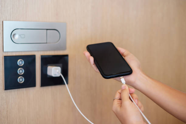 istock Hand Charging battery on mobile smartphone. Technology, multiple sharing and recharge concepts 1410017028