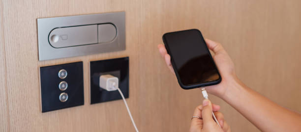 istock Hand Charging battery on mobile smartphone. Technology, multiple sharing and recharge concepts 1410017234