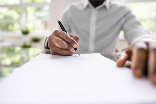 istock Agreement Form Signature. Hand Signing Paper 1410017365