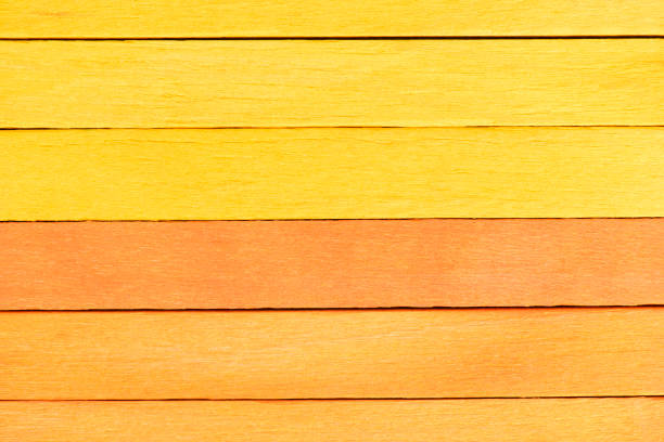 istock Bicolor background from yellow and orange wooden planks. 1410017886