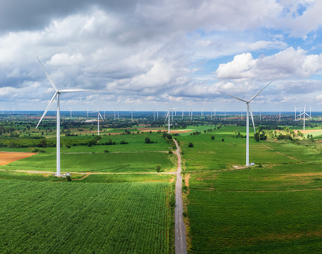 Aerial landscape view of group of windmills in a wind farm creating renewable energy at  Nakhon Ratchasima, Thailand