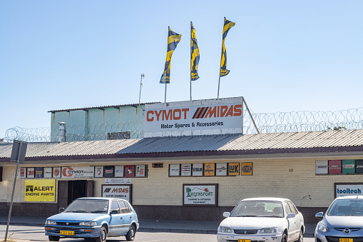 Cymot Midas Auto Parts Store on Independence Avenue at Katutura Township in Windhoek, Namibia, with car number plates and commercial signs visible.