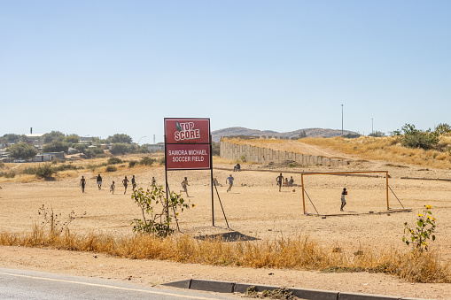 Soccer players visible at the Samora Machel Soccer Field at Katutura Township near Windhoek in Khomas Region, Namibia. Samora Machel was the first President of Mozambique from its independence in 1975.