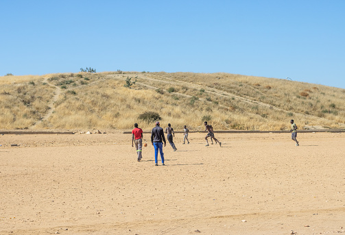 People visible at the Samora Machel Soccer Field at Katutura Township near Windhoek in Khomas Region, Namibia. Samora Machel was the first President of Mozambique from its independence in 1975.