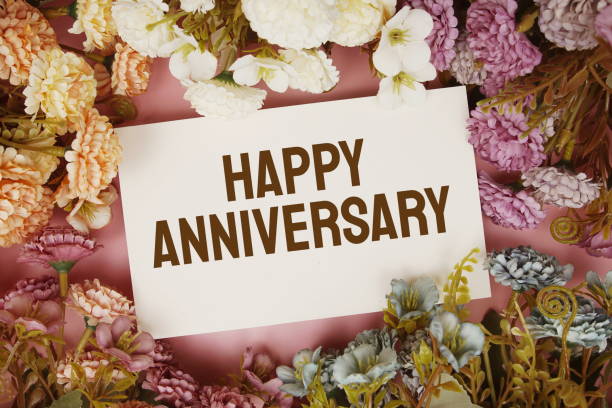 istock Happy Anniversary typography text with flowers frame on pink background 1410021848