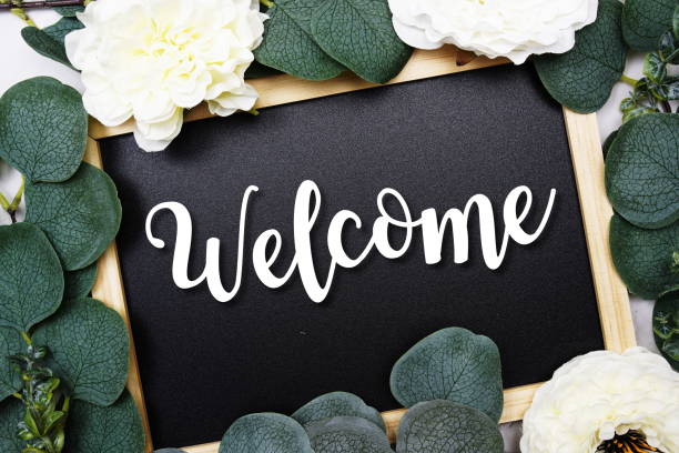 istock Welcome text on blackboard and eucalyptus leaves decoration on marble background 1410021928
