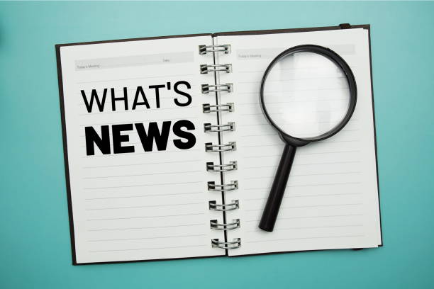 istock Whats News text on notepad and magnifying glass on blue background 1410022310