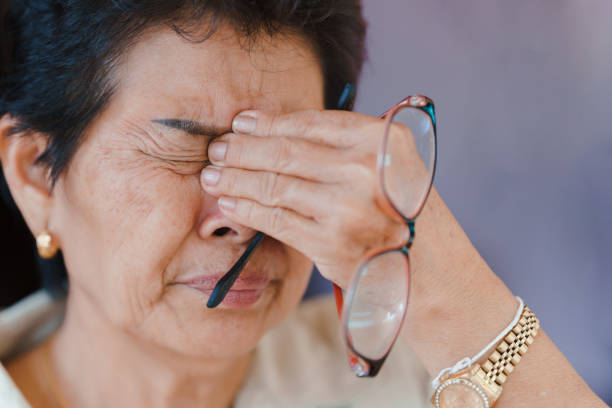 Elderly women with eye disease causing a lot of pain in the eyes. Concept of health problems in the elderly. Elderly women with eye disease causing a lot of pain in the eyes. Concept of health problems in the elderly. human eye scratching allergy rubbing stock pictures, royalty-free photos & images