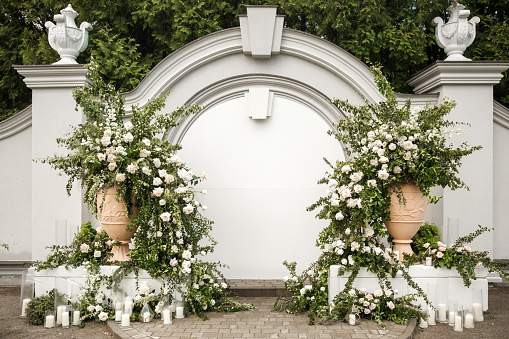 Arch for an outdoor wedding ceremony with candles.
